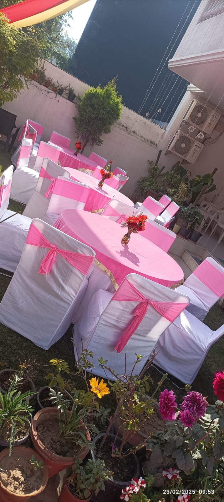 Elegant Day Seating with Round Tables and Pink Chair Covers