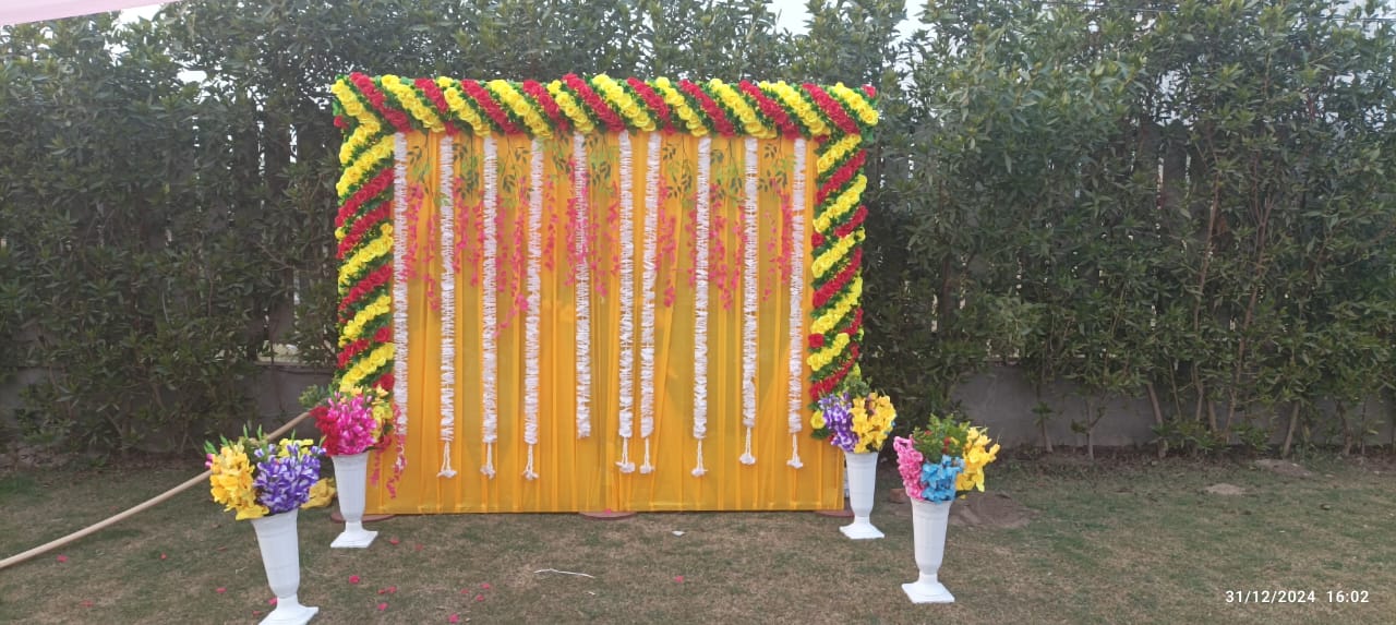 Yellow Fabric Backdrop decorated with Flowers for Outdoor Ceremony